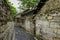 Ancient tile-roofed houses along stone-stacked alley in cloudy s