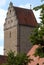 Ancient tower with the front of the roof in the form of stepped pyramid in the town of Dinkelsbuhl in Germany