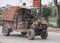 Ancient tractor truck loaded with bricks.