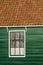 Ancient traditional old fashioned wood window and tile roof in Amsterdam, The Netherlands