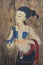Ancient Traditional painting of woman with costume on wooden brown backgrounds, thai style standing female drawing on wood