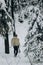 Ancient viking hunter walking in snow winter forest with steel a