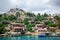 Ancient village of Simena with castle on mountain. Boat dock, beautiful landscape. Sea tour of Lycian underwater city on