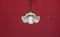 Ancient vintage lamp hanging from red ceiling background