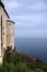 Ancient wall with little tower and sea vanishing in the sky with