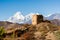 Ancient watch tower with mountain scenery.