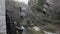 Ancient water mill in a stream. In the background a waterfall