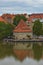 Ancient Water Tower reflected in water. Beautiful autumn landscape, embankment of Drava River. Famous touristic place