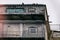 Ancient, weathered building with crumbling brick walls and old iron railings