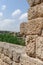 Ancient weathered stone wall in archeological park in Israel