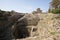 Ancient well inside the Roman ruins of Byblos and in the background the crusader castle. Byblos, Lebanon