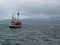 An ancient whaler sailing in Skjalfandi bay in northern Iceland near to Husavik looking for whales