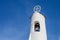 Ancient white bell tower against the blue sky. Porto Cervo, Sardinia