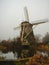 Ancient windmill on the shore of a lake.