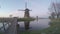 Ancient windmills on riverbank. Beauty of Holland. World most picturesque places. Old engineering constructions