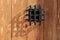 Ancient window black metal jail grid wooden door