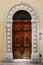 Ancient wood door of a historic building in Perugia (Tuscany, Italy)