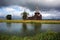 Ancient wooden church beyond the river,stormy sky