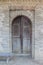 Ancient wooden door in a historic brick building in Tbilisi Open Air Museum of Ethnography. Georgia country