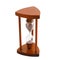 Ancient wooden hourglass over white