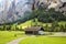 Ancient wooden house in the mountains overgrown with forest of Bernese Oberland