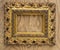 Ancient wooden ornate picture frame on wooden background