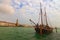 Ancient wooden two-masted ship moored in Venice near Punta della Dogana. Ancient sailboat in open air on the canal quay.