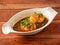 Anda Masala or Egg Curry is popular indian spicy food, served in a ceramic bowl over rustic wooden background. Selective focus