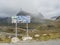 Andalsnes, Norway, September 7, 2019: Poster covered by colorful stick-on label at Lake Alnesvatnet with snow capped mountain peak