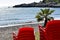 Andalusian beach with stacked red chairs of a typical beach bar