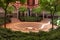 Andalusian courtyard surrounded by arches and columns with circular stepped fountain in the center. Seville, Andalusia