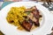 Andalusian cuisine, spicy cous-cous with grilled pork ham filet