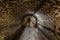 Anderlecht, Brussels, Belgium- Man walking in the industrial interiors of the sewer museum showing the main tunnel of the Chaussee