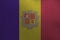 Andorra flag depicted in paint colors on old brushed metal plate or wall closeup. Textured banner on rough background