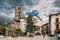 Andorra La Vella, Andorra. People Walking On Prince Benlloch Square Near Famous Church Of Saint Esteve. Esglesia De Sant