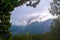 Andorra mountains with snow. View of snowy mountains through pine trees