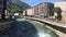 Andorra, a train crossing a bridge over a river in a city