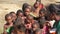 Andranovory, Madagascar - April 30, 2019: Group of unknown Malagasy kids standing together on sunny day in torn clothes - people