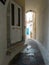 Andros island Chora, Cyclades Greece. Whitewashed walls, paved alley, house background. Vertical