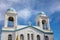 Andros island, Chora town, Cyclades Greece. Saint George church, blue sky. Upper part, under view