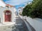 Andros island Greece. Cyclades whitewashed houses paved alleys at Chora town. Sea sky background