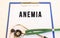 ANEMIA- text on medical folder with documents and stethoscope on white background