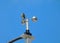 anemometer wind speed indicator measuring device under blue sky and clouds