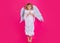 Angel child jump, kids jumping, full body in movement. Cute kid with angel wings isolated on pink studio background