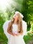 Angel children girl in forest with flower in hand