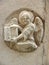 Angel holding a book carved into wall-Venice