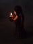 Angel holds a burning candle in the dark. background religion, p