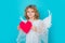 Angel kid with heart. Angel child. Isolated studio shot. Cute kid with angel wings. Cupid, valentines day concept.