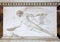 Angel relief on marble tomb in a graveyard, Italy