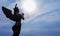 Angel sculpture on blue sky background concept of Religion